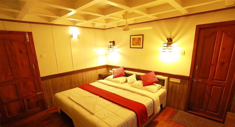 Bedroom with warm lighting and wooden doors