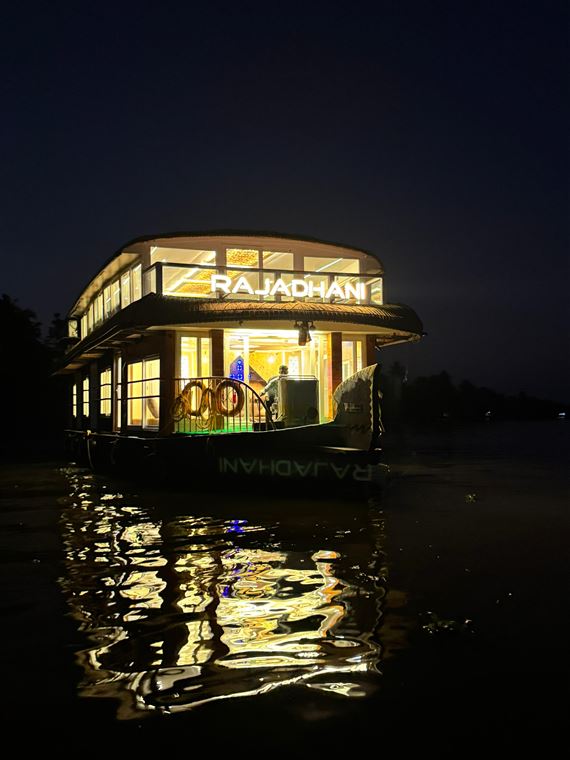 Houseboat lit up at night