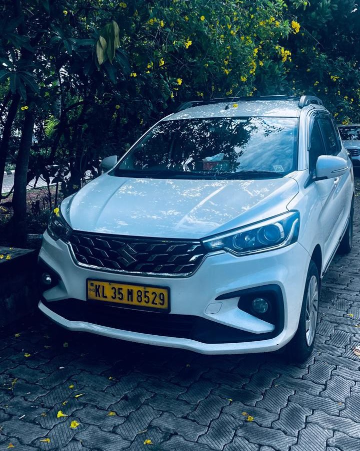 One of our cars: a white 7-seater MPV taxi